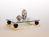 Table basse, mod&egrave;le sph&egrave;re en sycomore moir&eacute; et ch&ecirc;ne fonc&eacute;. Le dessus en dalle de verre compense en l&eacute;g&egrave;ret&eacute; l&rsquo;aspect affirm&eacute; de la base. 